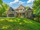 Charming home with a beautifully landscaped front yard, attached garage, and stone and wood facade at 445 Ridge Springs Dr, Chapel Hill, NC 27516