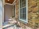 Charming stone porch with a small table and chairs for relaxing at 445 Ridge Springs Dr, Chapel Hill, NC 27516
