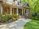 Inviting entryway with stone accents, manicured landscaping, and a cozy front porch at 445 Ridge Springs Dr, Chapel Hill, NC 27516