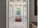 Bright hallway with neutral paint, white trim and doors, and a charming window seat at 445 Ridge Springs Dr, Chapel Hill, NC 27516