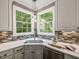 Eat-in kitchen offers an abundance of natural light from the corner windows at 445 Ridge Springs Dr, Chapel Hill, NC 27516