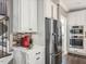 Gourmet kitchen features stainless steel appliances, white cabinets, and mosaic tile backsplash at 445 Ridge Springs Dr, Chapel Hill, NC 27516