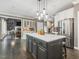 Open-concept kitchen with center island and stainless steel refrigerator at 445 Ridge Springs Dr, Chapel Hill, NC 27516