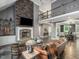 Spacious living room with stone fireplace, open floor plan, and views into the dining area at 445 Ridge Springs Dr, Chapel Hill, NC 27516