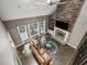 Aerial view of a living room with a fireplace, wood floors, and large windows for ample natural light at 445 Ridge Springs Dr, Chapel Hill, NC 27516