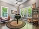 Stylish living room with hardwood floors, piano, harp, and lots of natural light at 445 Ridge Springs Dr, Chapel Hill, NC 27516