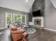 Inviting living room with vaulted ceiling, stone fireplace, and large windows overlooking nature at 445 Ridge Springs Dr, Chapel Hill, NC 27516
