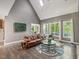 Bright living room featuring vaulted ceiling, large windows, and a comfortable seating area at 445 Ridge Springs Dr, Chapel Hill, NC 27516