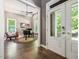 Cozy living room with hardwood floors, piano, chair, and great natural light at 445 Ridge Springs Dr, Chapel Hill, NC 27516