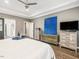Bright main bedroom with hardwood floors, gray walls, and a ceiling fan at 445 Ridge Springs Dr, Chapel Hill, NC 27516