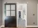 Entry to a main bedroom reveals a frosted sliding barn door, wood floors, and fresh paint at 445 Ridge Springs Dr, Chapel Hill, NC 27516