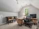 This home office provides a dedicated workspace with good light, neutral colors, and comfortable seating at 445 Ridge Springs Dr, Chapel Hill, NC 27516
