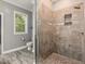 Shower featuring neutral tiling, pebble floor, window, and toilet at 445 Ridge Springs Dr, Chapel Hill, NC 27516