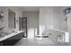 Elegant bathroom featuring marble walls, soaking tub, and a double vanity at 4500 Latimer Rd, Raleigh, NC 27609
