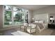 Bright bedroom with large windows, neutral colors, and two armchairs at 4500 Latimer Rd, Raleigh, NC 27609