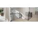 Hallway and staircase showcasing modern design with black metal railings and light wood floors at 4500 Latimer Rd, Raleigh, NC 27609
