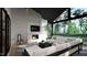 Cozy living room with a stone fireplace, comfortable seating and large windows overlooking the outdoor greenery at 4500 Latimer Rd, Raleigh, NC 27609