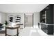 Stylish living room with a wet bar featuring black cabinetry, gold hardware and marble countertops at 4500 Latimer Rd, Raleigh, NC 27609