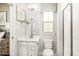 Well-lit bathroom featuring a white vanity, a toilet, and a glass-enclosed shower at 488 Freedom Trail Dr, Angier, NC 27592