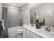 Bright bathroom features double vanity, gray tile, framed animal art, and shower/tub combo at 488 Freedom Trail Dr, Angier, NC 27592