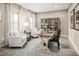 Bright home office with a work desk, two chairs and large windows providing an inspiring atmosphere at 488 Freedom Trail Dr, Angier, NC 27592