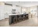 Stylish kitchen with white cabinets, stainless steel appliances, island seating, and an adjacent dining area at 488 Freedom Trail Dr, Angier, NC 27592