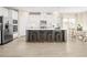 Bright kitchen with white cabinets, stainless steel appliances, and a large island with seating at 488 Freedom Trail Dr, Angier, NC 27592