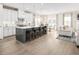 Open concept living room featuring white cabinets, island seating, a dining area, and a comfortable seating area at 488 Freedom Trail Dr, Angier, NC 27592