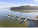 This aerial view highlights a private dock and calm waters, offering a picturesque waterfront lifestyle at 50 Tyler Ct, Henderson, NC 27537