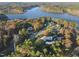 Stunning aerial view of lakeside homes nestled among colorful fall foliage at 50 Tyler Ct, Henderson, NC 27537