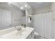 Clean and bright bathroom with a white vanity, large mirror, and neutral décor at 50 Tyler Ct, Henderson, NC 27537