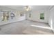 Large bedroom with neutral walls, carpet, three windows and a ceiling fan at 50 Tyler Ct, Henderson, NC 27537