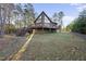 Inviting exterior of a cabin-style home with a wooden deck and natural surroundings at 50 Tyler Ct, Henderson, NC 27537