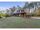 Charming home with a welcoming porch, featuring an American flag and lush landscaping at 50 Tyler Ct, Henderson, NC 27537