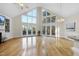 Bright, open living room with vaulted ceilings, hardwood floors, and large windows at 50 Tyler Ct, Henderson, NC 27537