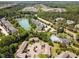 An aerial view shows a neighborhood with a lake, pool, and parking lots at 509 Darby Glen Ln, Durham, NC 27713