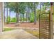 Backyard with trees, rocks, trellis, and concrete patio at 509 Darby Glen Ln, Durham, NC 27713
