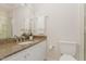 Granite countertop bathroom with white cabinets, modern fixtures, and a glass-door shower at 509 Darby Glen Ln, Durham, NC 27713