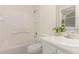 Full bathroom featuring a white tub and shower, toilet, vanity, and a large window at 509 Darby Glen Ln, Durham, NC 27713