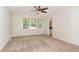Spacious bedroom featuring natural light, carpet floors, ceiling fan, and an ensuite bathroom at 509 Darby Glen Ln, Durham, NC 27713