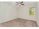 Empty bedroom with carpet floors, natural light, and a ceiling fan at 509 Darby Glen Ln, Durham, NC 27713