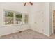 Bright bedroom features neutral carpet, closet, and large window letting in natural light at 509 Darby Glen Ln, Durham, NC 27713