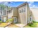 Rear exterior of townhome with siding, windows, patio, and green yard at 509 Darby Glen Ln, Durham, NC 27713