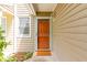 Close-up view of the front door entrance with a storm door, new lighting and a welcoming door mat at 509 Darby Glen Ln, Durham, NC 27713