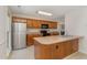 Well-equipped kitchen with stainless steel appliances, wooden cabinetry, and laminate countertops at 509 Darby Glen Ln, Durham, NC 27713