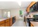 Bright kitchen featuring wood cabinets, updated appliances, and a view of the backyard at 509 Darby Glen Ln, Durham, NC 27713