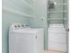 Well-lit laundry room featuring a Whirlpool washer and dryer and wire shelving at 509 Darby Glen Ln, Durham, NC 27713