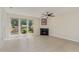 Bright living room featuring a ceiling fan, modern fireplace, and large windows overlooking a wooded area at 509 Darby Glen Ln, Durham, NC 27713
