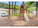 Outdoor playground with swings, climbing wall, slide, and playhouse at 509 Darby Glen Ln, Durham, NC 27713