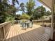 Wooden deck area with outdoor seating offering a relaxing outdoor space with trees at 509 E Millbrook Rd, Raleigh, NC 27609